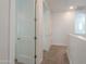 Bright hallway with neutral carpet and white walls, leading to bedrooms and other living spaces at 277 W Glacier Bay Dr, San Tan Valley, AZ 85140