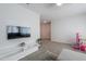Open-concept living room with neutral tones, large TV, and toy area at 277 W Glacier Bay Dr, San Tan Valley, AZ 85140