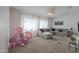 Living room with a comfortable sectional and a decorative doll house at 277 W Glacier Bay Dr, San Tan Valley, AZ 85140