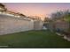 Backyard featuring an artificial lawn and a block wall with stairs leading to an upper level at 29599 N 106Th Pl, Scottsdale, AZ 85262