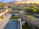 Modern home with artificial turf, swimming pool and spa nestled in lush landscaping with a view at 29599 N 106Th Pl, Scottsdale, AZ 85262