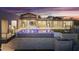 Luxury backyard features a modern pool with LED lighting, manicured landscaping, and a custom stone privacy wall at 29599 N 106Th Pl, Scottsdale, AZ 85262