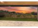 Gorgeous backyard view with patio, artificial turf, and desert landscaping providing a serene outdoor space at 29599 N 106Th Pl, Scottsdale, AZ 85262