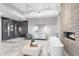 Bright bathroom featuring a soaking tub, modern fireplace, vanity with a round mirror, and a glass walk-in shower at 29599 N 106Th Pl, Scottsdale, AZ 85262