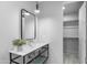 Modern bathroom with floating vanity, sleek mirror and light fixtures, and a plant for decor at 29599 N 106Th Pl, Scottsdale, AZ 85262