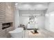 Bright bathroom featuring a soaking tub next to a modern fireplace and a vanity with a round mirror at 29599 N 106Th Pl, Scottsdale, AZ 85262