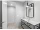 Modern bathroom features sleek vanity with open metal frame, contemporary mirror, and stylish pendant lighting at 29599 N 106Th Pl, Scottsdale, AZ 85262