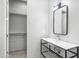 Stylish bathroom featuring a modern sink with black metal frame, large mirror, and walk-in closet at 29599 N 106Th Pl, Scottsdale, AZ 85262