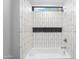 Bathroom featuring a white bathtub with shower and white subway tile at 29599 N 106Th Pl, Scottsdale, AZ 85262
