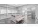 Spacious walk-in closet featuring custom shelving and drawers, center island, and bench seating at 29599 N 106Th Pl, Scottsdale, AZ 85262