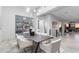 Modern dining room with stylish seating, decorative lighting, and convenient access to a wine room at 29599 N 106Th Pl, Scottsdale, AZ 85262