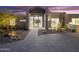 Modern home featuring covered entry with desert landscaping and stone driveway at 29599 N 106Th Pl, Scottsdale, AZ 85262
