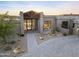 Modern home featuring a covered entry, desert landscaping, and stone driveway at 29599 N 106Th Pl, Scottsdale, AZ 85262