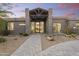 Beautifully landscaped desert home with modern architecture, and a stone driveway leading to the front entrance at 29599 N 106Th Pl, Scottsdale, AZ 85262