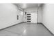 Clean, well-lit garage with epoxy flooring and a modern glass-panel door at 29599 N 106Th Pl, Scottsdale, AZ 85262