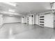 Spacious garage with epoxy flooring offering ample storage space and multiple garage doors at 29599 N 106Th Pl, Scottsdale, AZ 85262
