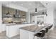 An open kitchen is equipped with stainless steel appliances, marble countertops, and sleek white cabinetry at 29599 N 106Th Pl, Scottsdale, AZ 85262