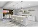 Kitchen features a granite island and dining table with seating, and bar with open shelving at 29599 N 106Th Pl, Scottsdale, AZ 85262