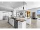 An open kitchen is equipped with stainless steel appliances, marble countertops, and sleek white cabinetry at 29599 N 106Th Pl, Scottsdale, AZ 85262