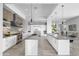 An open kitchen is equipped with stainless steel appliances, marble countertops, and sleek white cabinetry at 29599 N 106Th Pl, Scottsdale, AZ 85262