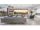 Spacious living room with comfortable seating, a cozy fireplace, and panoramic views of the desert landscape at 29599 N 106Th Pl, Scottsdale, AZ 85262