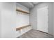 Entryway/Mudroom with a built-in bench, shelving, coat hooks, and modern door at 29599 N 106Th Pl, Scottsdale, AZ 85262