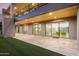 Covered patio with travertine tiles, sliding glass doors, and views of the backyard at 29599 N 106Th Pl, Scottsdale, AZ 85262