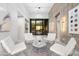 Bright and airy sitting area with modern furniture, decorative walls, and access to the outdoors at 29599 N 106Th Pl, Scottsdale, AZ 85262