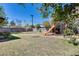 Expansive backyard featuring a play structure, grass, and a landscaped area with a stone path at 304 W 6Th St, Mesa, AZ 85201