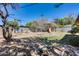 Spacious backyard with a playground, mature trees, and garden beds for planting at 304 W 6Th St, Mesa, AZ 85201