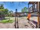 View of the backyard, showing the play structure, covered patio, and spacious grassy area at 304 W 6Th St, Mesa, AZ 85201