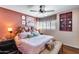 Charming bedroom featuring a brick wall, plush bedding, and natural light from the window at 304 W 6Th St, Mesa, AZ 85201