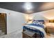 Bedroom features a cozy bed with a dark ceiling and white walls, offering simplicity and comfort at 304 W 6Th St, Mesa, AZ 85201