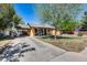 Charming home with a well-manicured front yard, mature trees, and inviting front porch at 304 W 6Th St, Mesa, AZ 85201