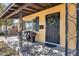 Inviting front porch with a cozy bench, decorative flower pot, and stylish front door at 304 W 6Th St, Mesa, AZ 85201