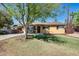 Charming home with a large shade tree in the front yard and covered porch seating area at 304 W 6Th St, Mesa, AZ 85201