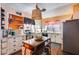 Well-lit kitchen featuring white cabinets, an island, and tile countertops at 304 W 6Th St, Mesa, AZ 85201