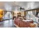 Cozy living room with a fireplace, ceiling fan, and multiple access points to the outside at 304 W 6Th St, Mesa, AZ 85201