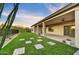 Expansive backyard with artificial grass, pavers, covered patio, ideal for lounging or al fresco dining at 32806 N 55Th Pl, Cave Creek, AZ 85331