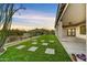Inviting backyard with artificial grass, pavers, and covered patio is perfect for outdoor living and entertaining at 32806 N 55Th Pl, Cave Creek, AZ 85331