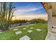 Lush backyard featuring artificial grass, desert landscaping, and views at 32806 N 55Th Pl, Cave Creek, AZ 85331