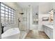Bright bathroom with marble-look shower, soaking tub, and dual sink vanity at 32806 N 55Th Pl, Cave Creek, AZ 85331