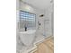 Modern bathroom featuring a soaking tub, a glass-enclosed shower, and marble accents at 32806 N 55Th Pl, Cave Creek, AZ 85331