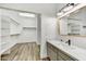 Bathroom with a modern vanity with designer sink and a spacious walk-in closet at 32806 N 55Th Pl, Cave Creek, AZ 85331