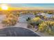 Aerial view of a home with a three-car garage, desert landscaping, and beautiful mountain views at 32806 N 55Th Pl, Cave Creek, AZ 85331