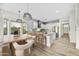 Modern kitchen featuring white cabinets, a stylish dining area, and views of the outdoor landscape at 32806 N 55Th Pl, Cave Creek, AZ 85331