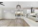 Open kitchen with white cabinets, granite countertops, tile backsplash, and a large island at 32806 N 55Th Pl, Cave Creek, AZ 85331
