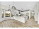 Open kitchen with white cabinets, granite countertops and large island, pendant lighting, and backyard view at 32806 N 55Th Pl, Cave Creek, AZ 85331