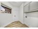 Bright laundry room with window, utility sink, and direct access to the garage at 32806 N 55Th Pl, Cave Creek, AZ 85331