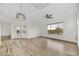 Bright living room featuring wood floors, ceiling fan, and french doors leading to patio at 32806 N 55Th Pl, Cave Creek, AZ 85331